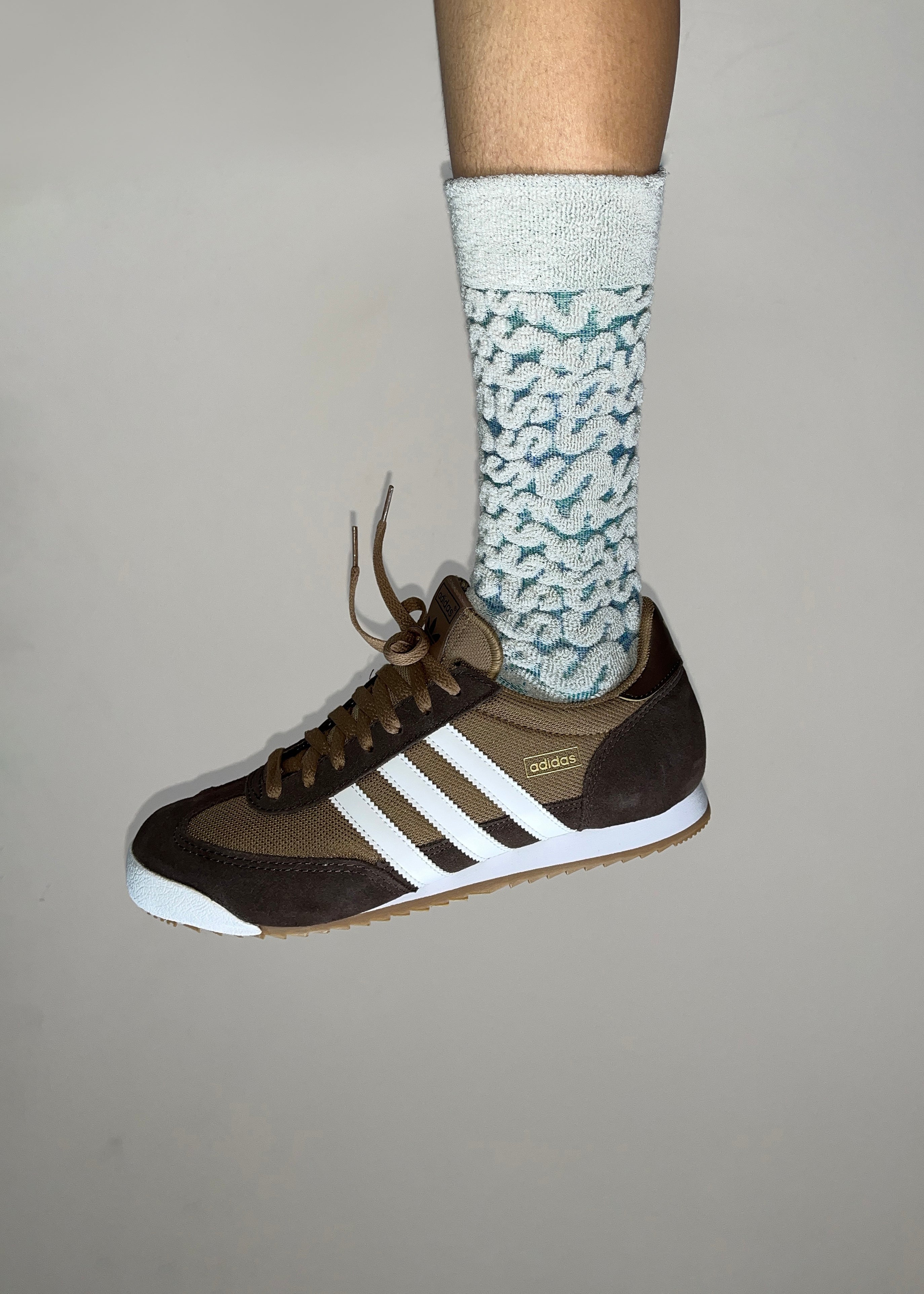 Close up on a person wearing the Adidas Sneaks with The Coral Cotton Terry Socks in Color Galaxy Space