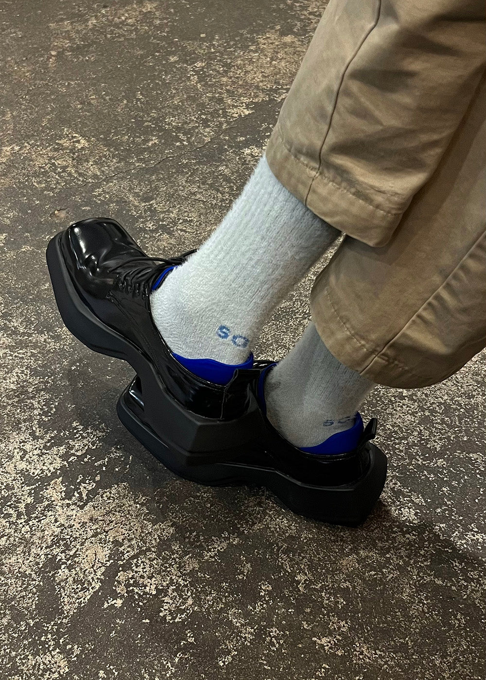 A person wearing the Troll Mohair socks in Light Grey