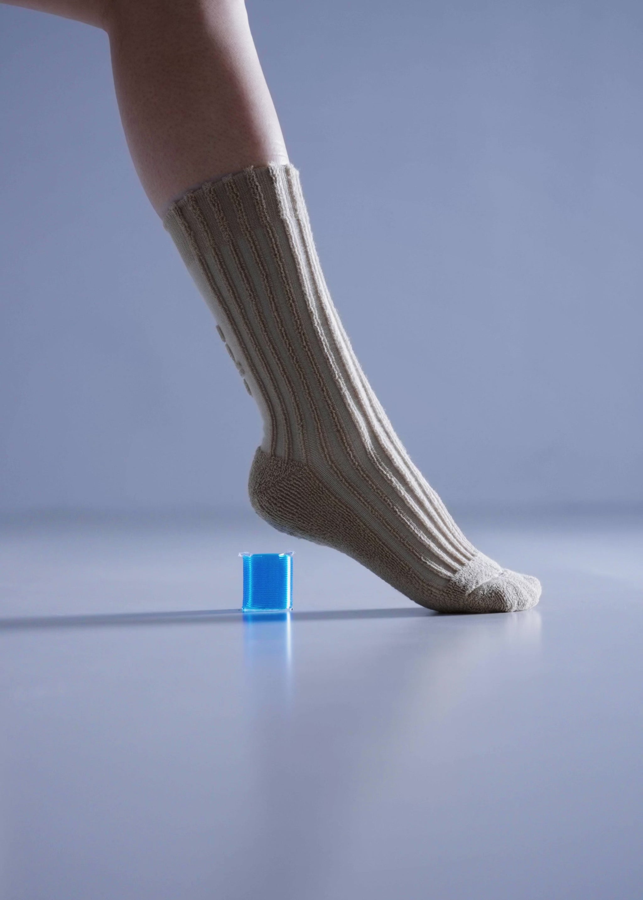 Model Interacting with a Spring while wearing the Column Cotton Terry Socks in Different Colors