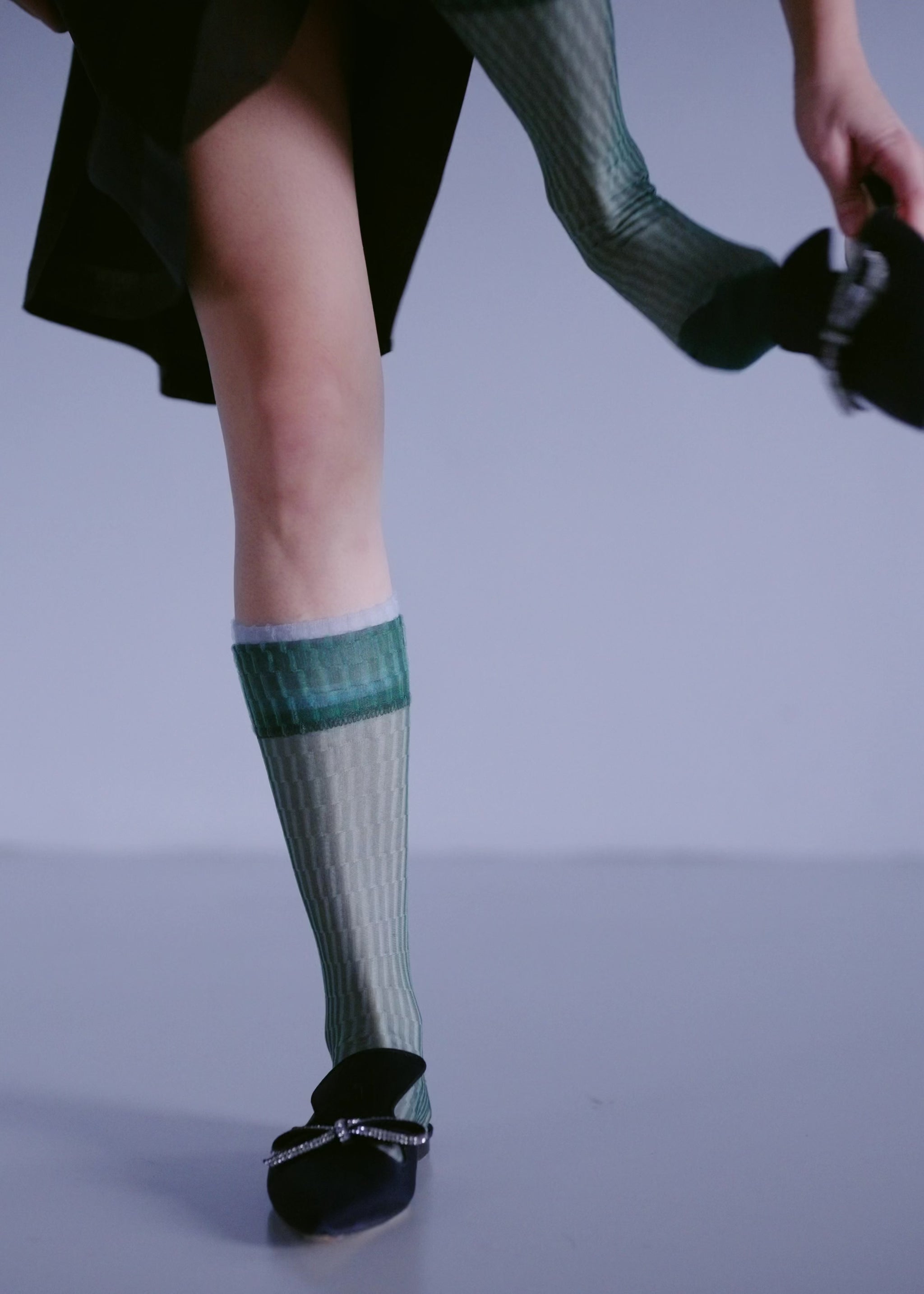 model changing into different sheer socks